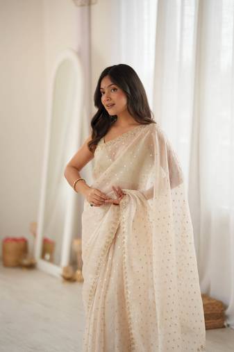 Cream chiffon zari embroidered saree with unstitched blouse piece.