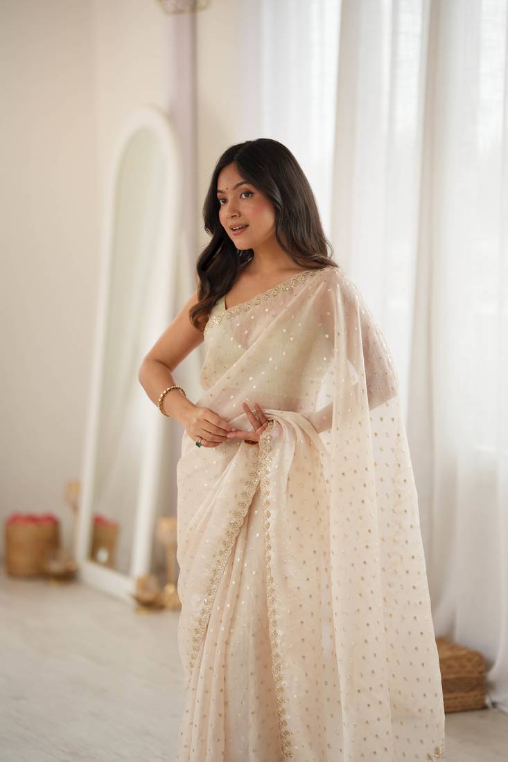 Cream chiffon zari embroidered saree with unstitched blouse piece.