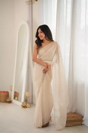 Cream chiffon zari embroidered saree with unstitched blouse piece.