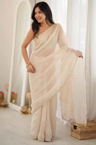 Cream chiffon zari embroidered saree with unstitched blouse piece.