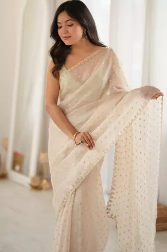 Cream chiffon zari embroidered saree with unstitched blouse piece.