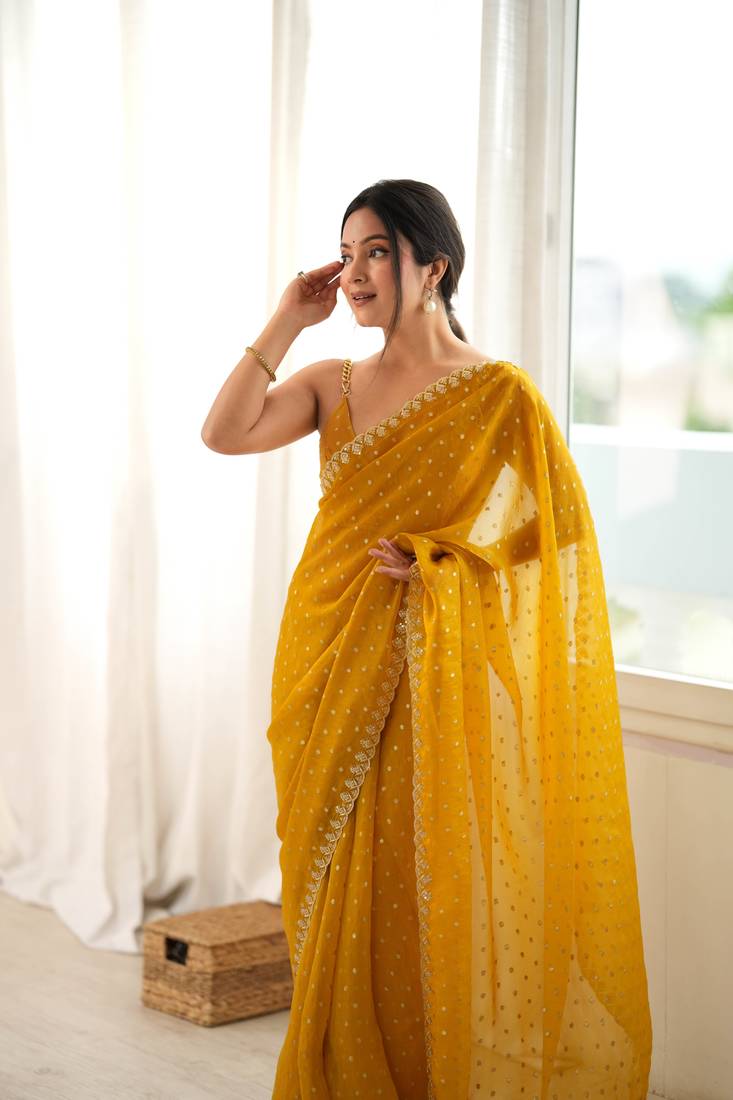 Mustard chiffon zari embroidered saree with unstitched blouse piece.