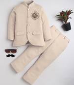 Boys cream lycra floral embroidered bandhgala blazer & trouser set with metal crest