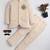 Boys cream lycra floral embroidered bandhgala blazer & trouser set with metal crest