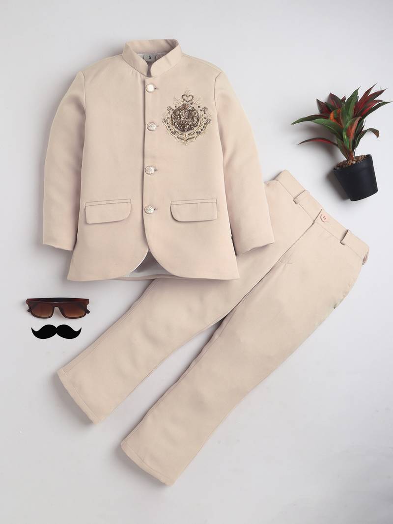 Boys cream lycra floral embroidered bandhgala blazer & trouser set with metal crest