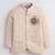Boys cream lycra floral embroidered bandhgala blazer & trouser set with metal crest