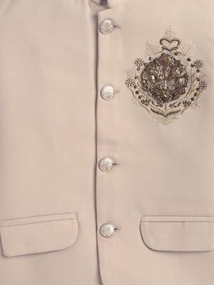 Boys cream lycra floral embroidered bandhgala blazer & trouser set with metal crest 4