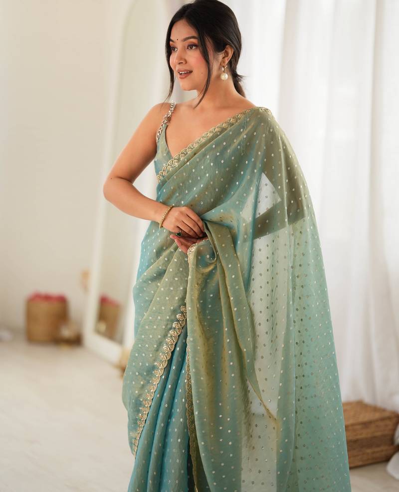 Rama chiffon zari embroidered saree with unstitched blouse piece.