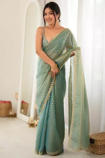 Rama chiffon zari embroidered saree with unstitched blouse piece.