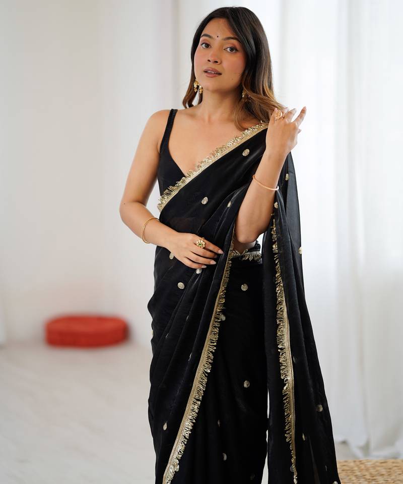 Black tissue satin sequins saree with unstitched blouse piece.