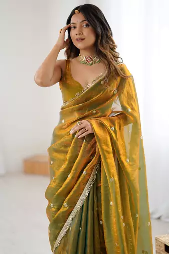 Gold tissue satin sequins saree with unstitched blouse piece.