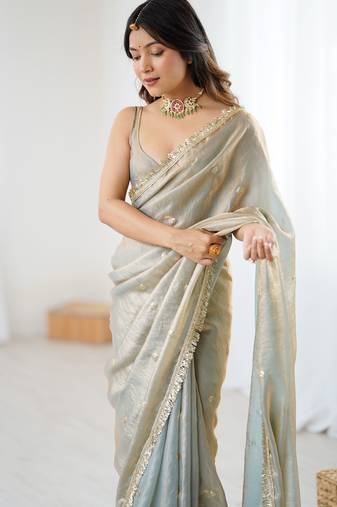 Grey tissue satin sequins saree with unstitched blouse piece.