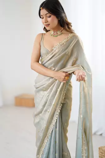 Grey tissue satin sequins saree with unstitched blouse piece.