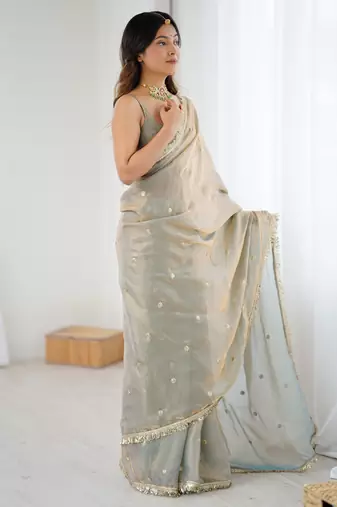 Grey tissue satin sequins saree with unstitched blouse piece.