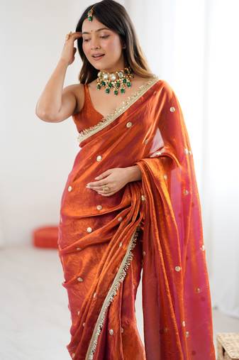 Orange tissue satin sequins saree with unstitched blouse piece.