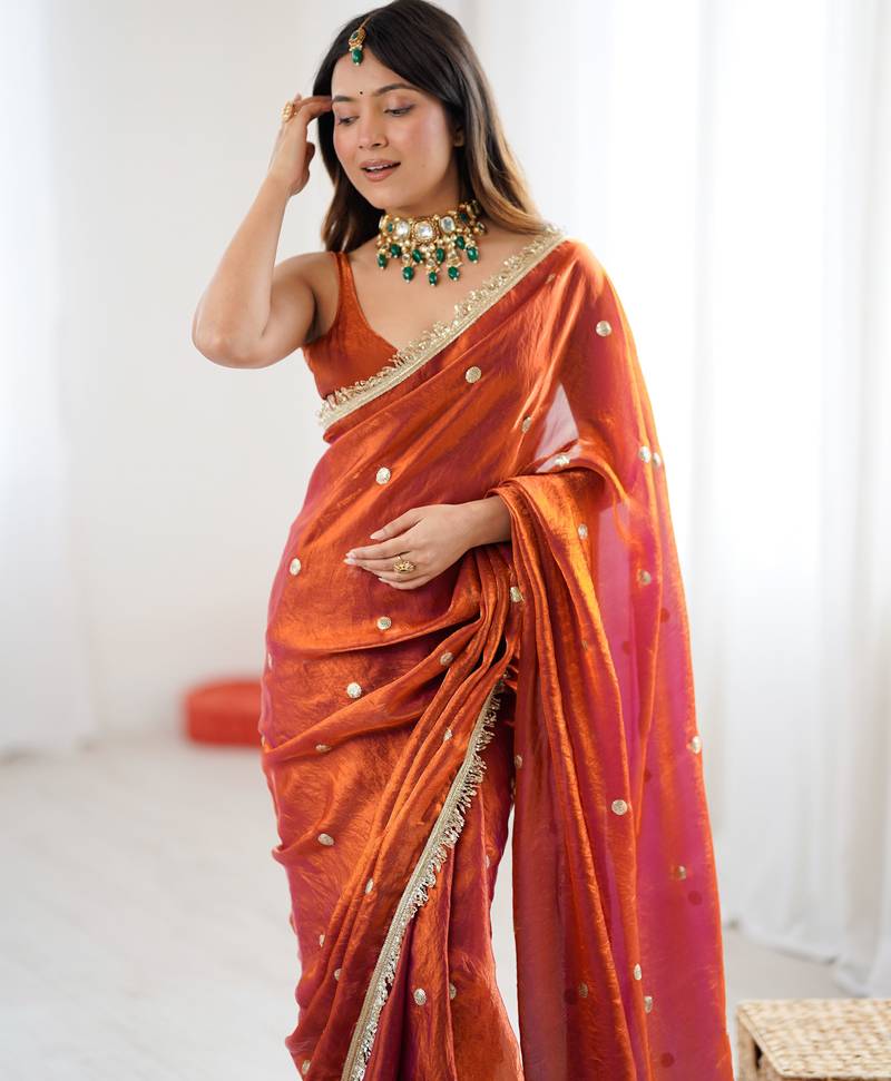 Orange tissue satin sequins saree with unstitched blouse piece.