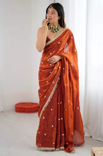 Orange tissue satin sequins saree with unstitched blouse piece.