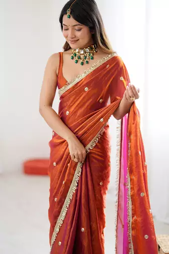 Orange tissue satin sequins saree with unstitched blouse piece.