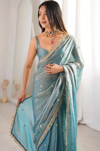 Sky blue tissue satin sequins saree with unstitched blouse piece.