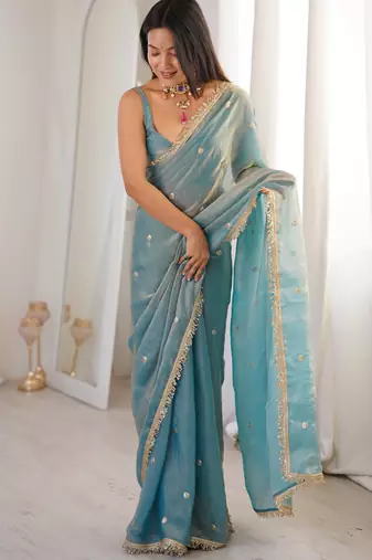 Sky blue tissue satin sequins saree with unstitched blouse piece.