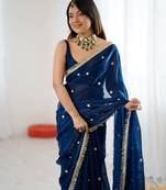 Teal tissue satin sequins saree with unstitched blouse piece.
