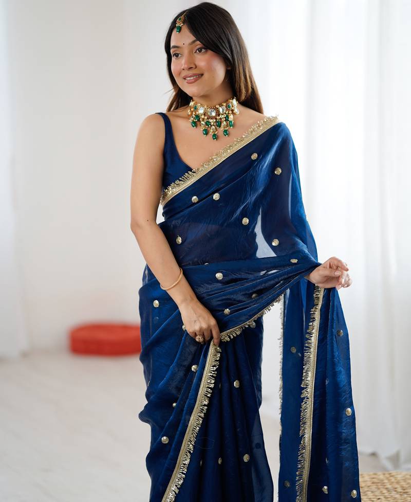 Teal tissue satin sequins saree with unstitched blouse piece.
