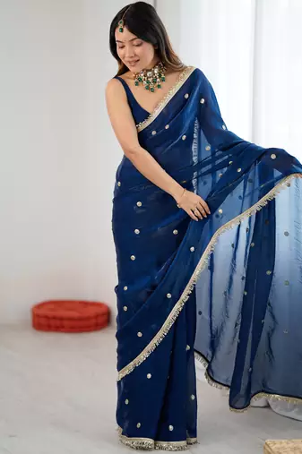 Teal tissue satin sequins saree with unstitched blouse piece.