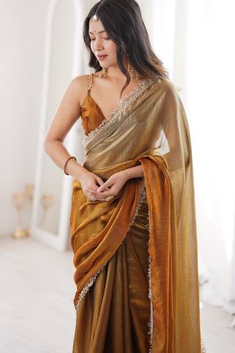 Gold tissue satin sequins saree with unstitched blouse piece.
