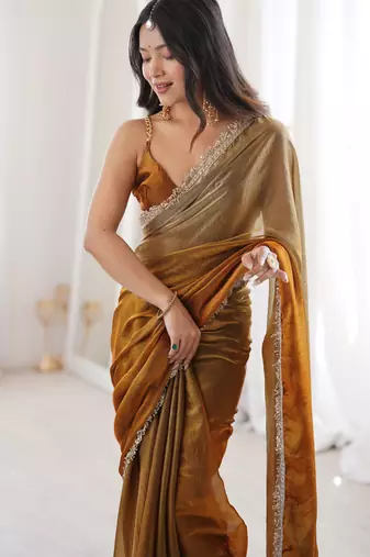Gold tissue satin sequins saree with unstitched blouse piece.