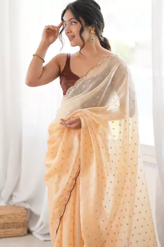 Mustard tissue embellished saree with unstitched blouse piece.