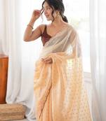 Mustard tissue embellished saree with unstitched blouse piece.