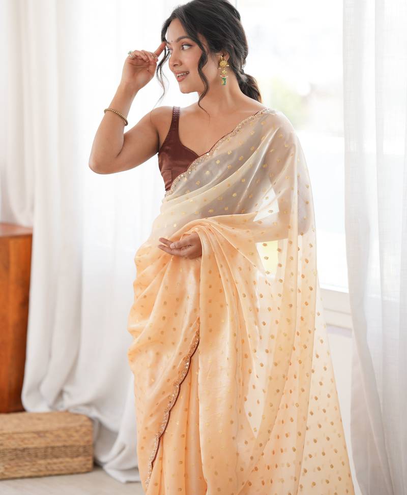 Mustard tissue embellished saree with unstitched blouse piece.