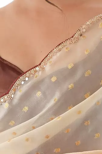 Mustard tissue embellished saree with unstitched blouse piece.