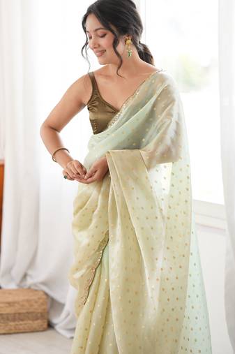 Olive tissue embellished saree with unstitched blouse piece.