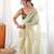 Olive tissue embellished saree with unstitched blouse piece.