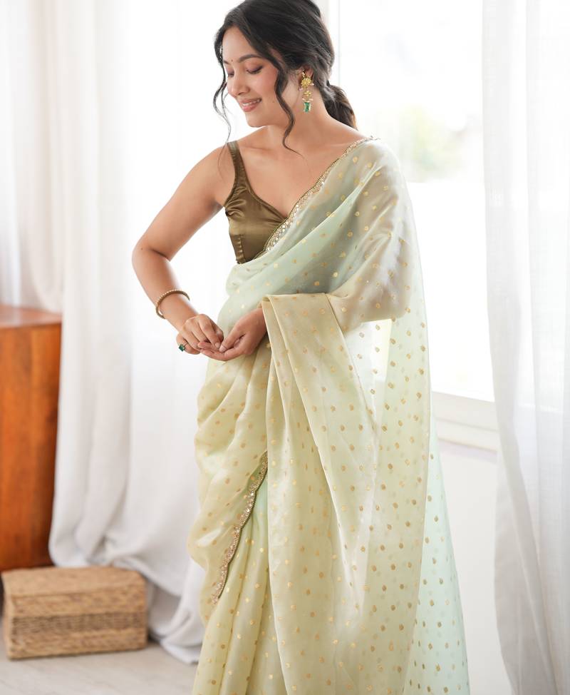 Olive tissue embellished saree with unstitched blouse piece.