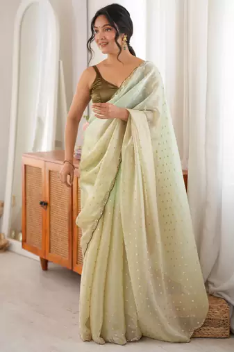 Olive tissue embellished saree with unstitched blouse piece.