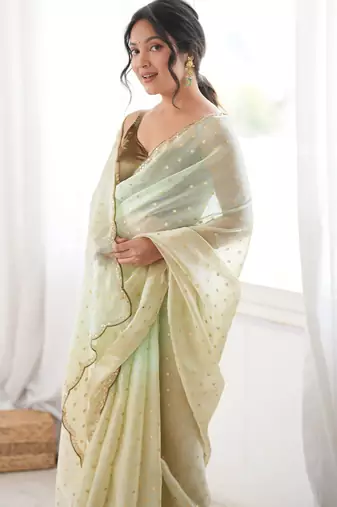 Olive tissue embellished saree with unstitched blouse piece.