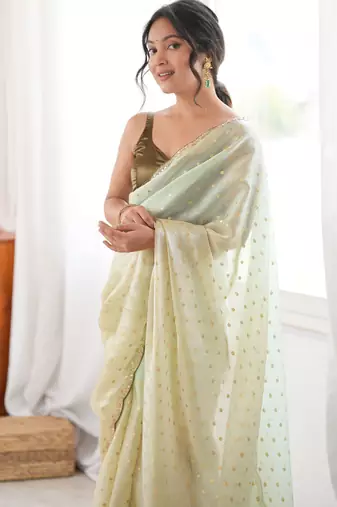 Olive tissue embellished saree with unstitched blouse piece.