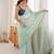 Sea green tissue embellished saree with unstitched blouse piece.