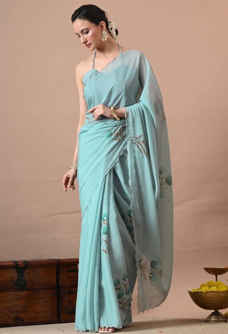 Women's turquoise floral print georgette saree with unstitched blouse piece
