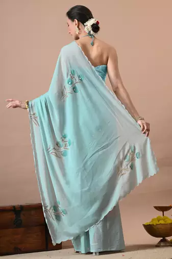 Women's turquoise floral print georgette saree with unstitched blouse piece