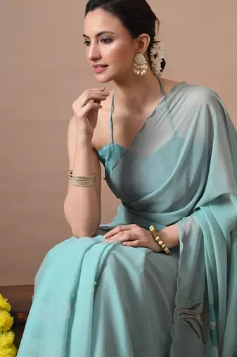 Women's turquoise floral print georgette saree with unstitched blouse piece