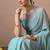 Women's turquoise floral print georgette saree with unstitched blouse piece