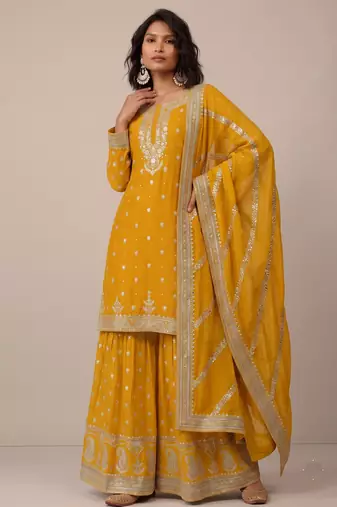 Yellow heavy silk blend  classic embroidered party wear salwar suit