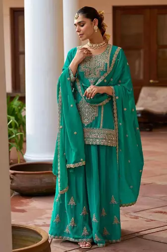  emerald green silk blend zari embroidery thread work motif work sequined and detailed border semi stitched suit