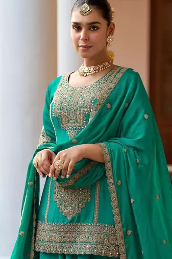  emerald green silk blend zari embroidery thread work motif work sequined and detailed border semi stitched suit