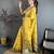 yellow color muga cotton blend woven with flower printed saree