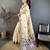 cream color muga cotton blend woven with flower printed saree