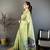 green color muga cotton blend woven motif saree with blouse